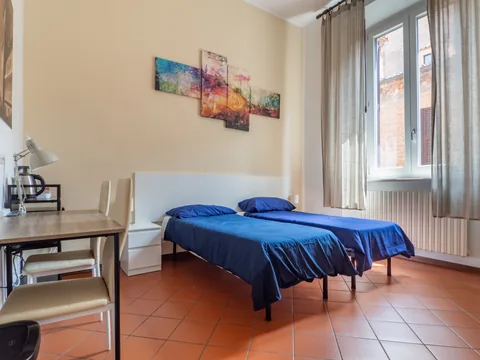 Bedroom with a blue bed and desk