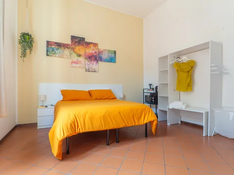 Bedroom with an orange bed, wide view