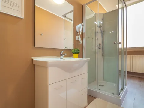 Bathroom with shower and vanity unit