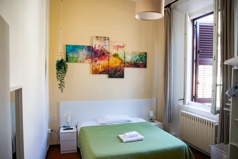 Bedroom with a green bed and window