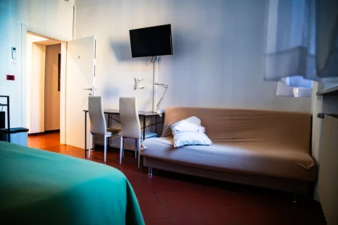 Bedroom with bed, sofa and television